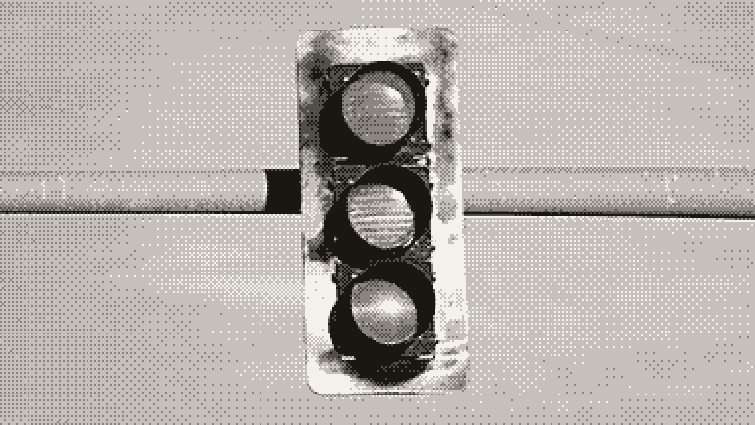 A traffic light hanging from a metal pole