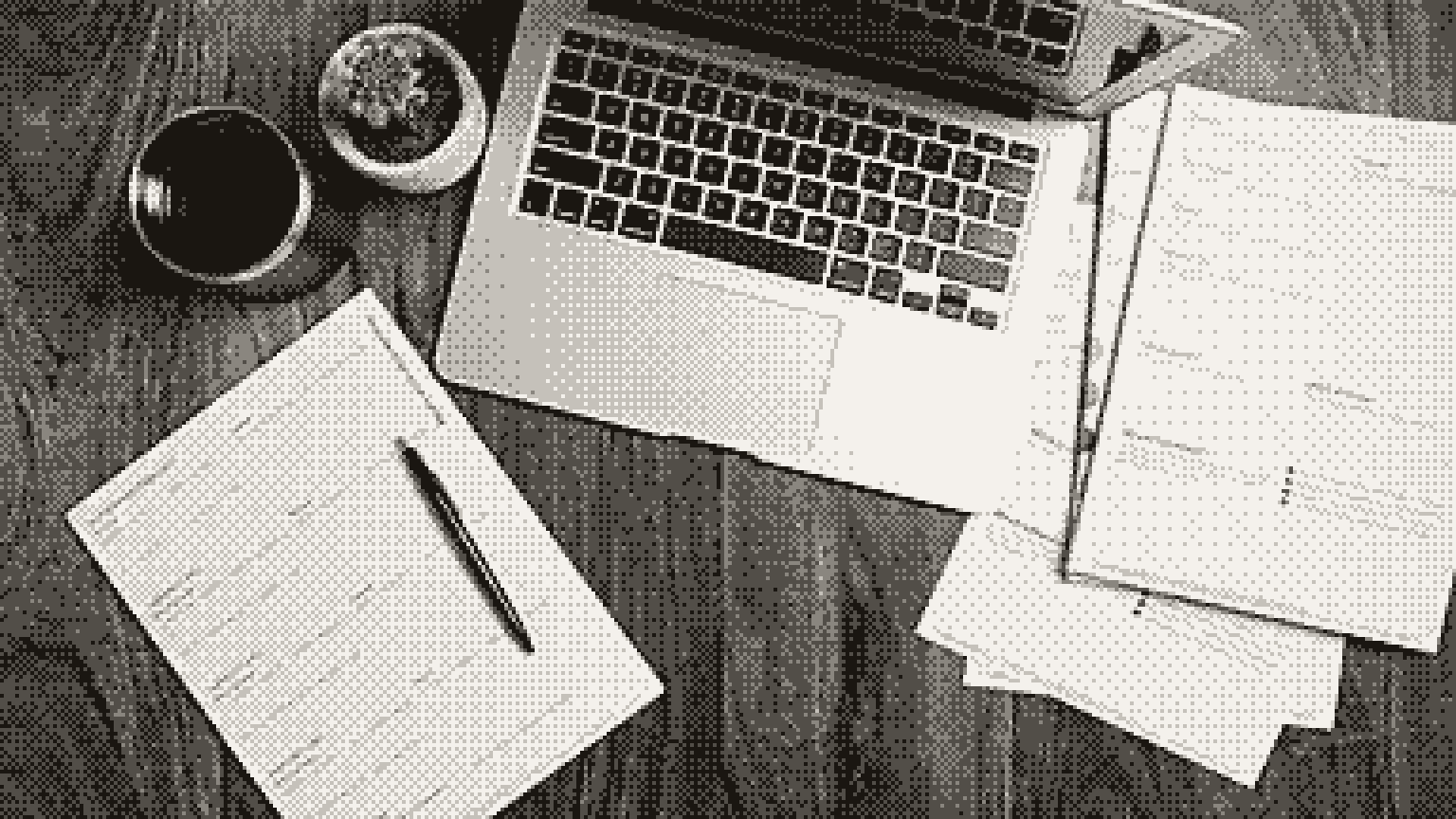 A laptop, printed pages and a pen on a wooden desk, seen from above