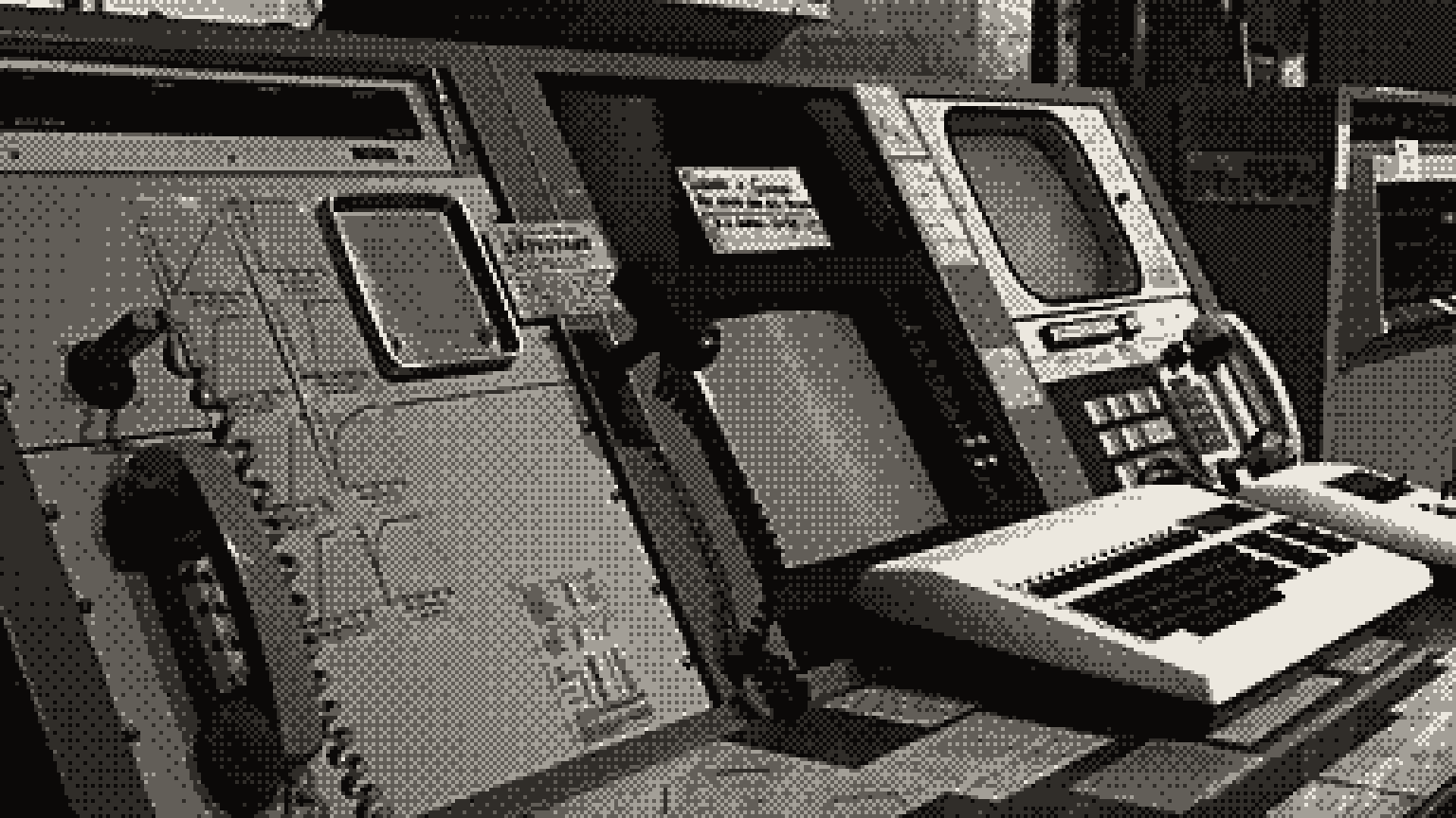 An old control console with a telephone handset, monitors and a keyboard